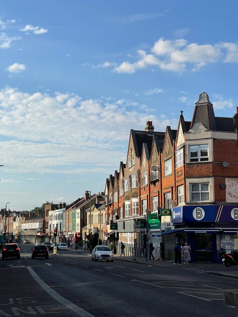 There is no image of flowers, floral arrangements, or delivery scenes in the provided photograph of Feltham High Street TW13. The image depicts a street view with a row of traditional brick and semi-d